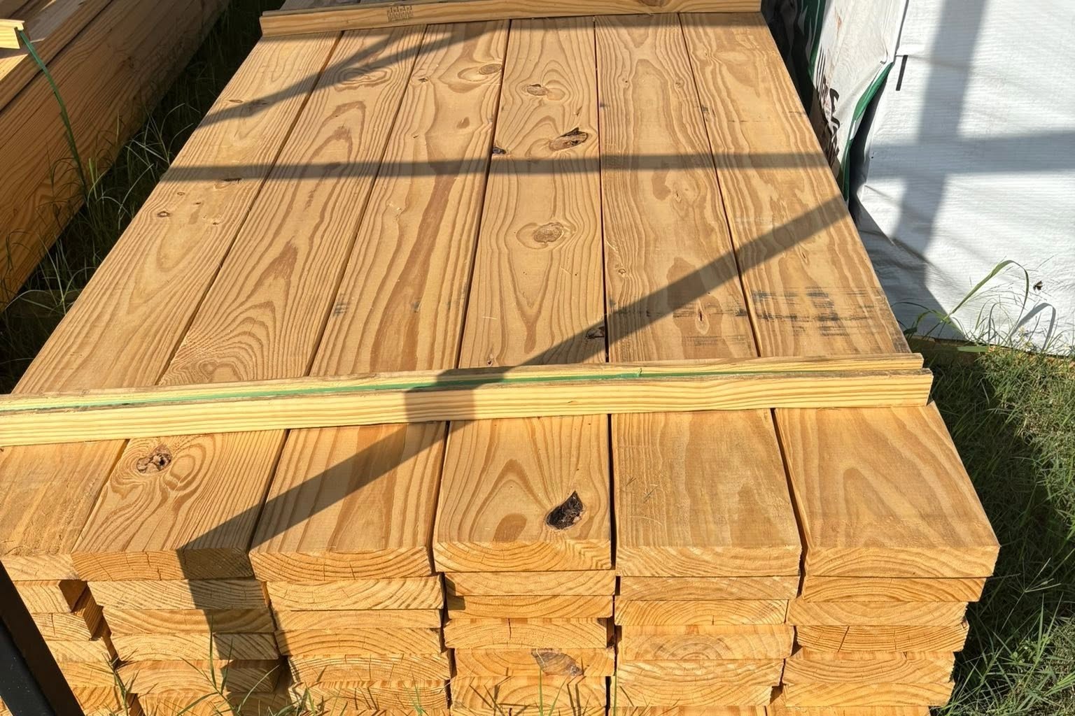 Freshly treated deck boards banded in a stack