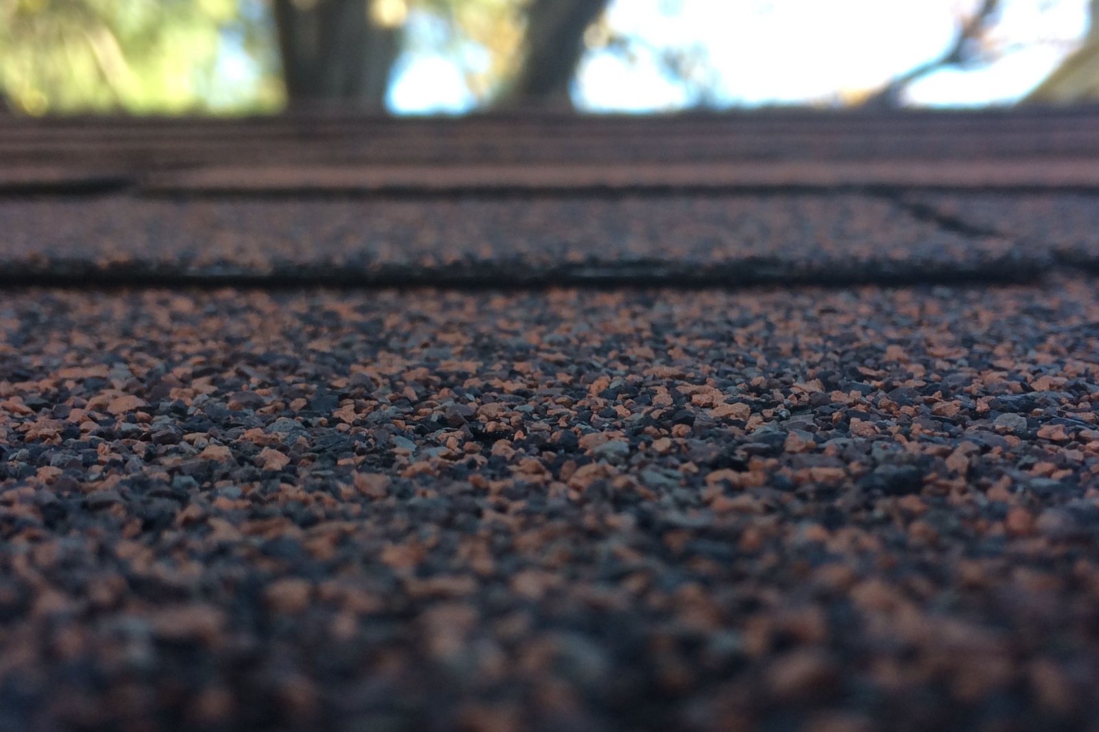 Close up of laminated asphalt shingle courses showing the texture and shadow line