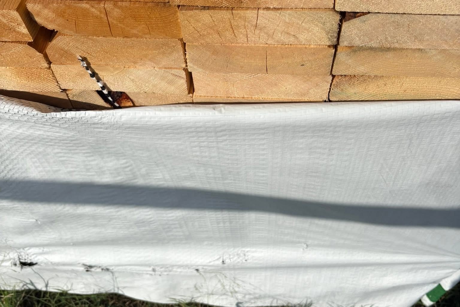 Rough sawn lumber wrapped and stacked in the yard